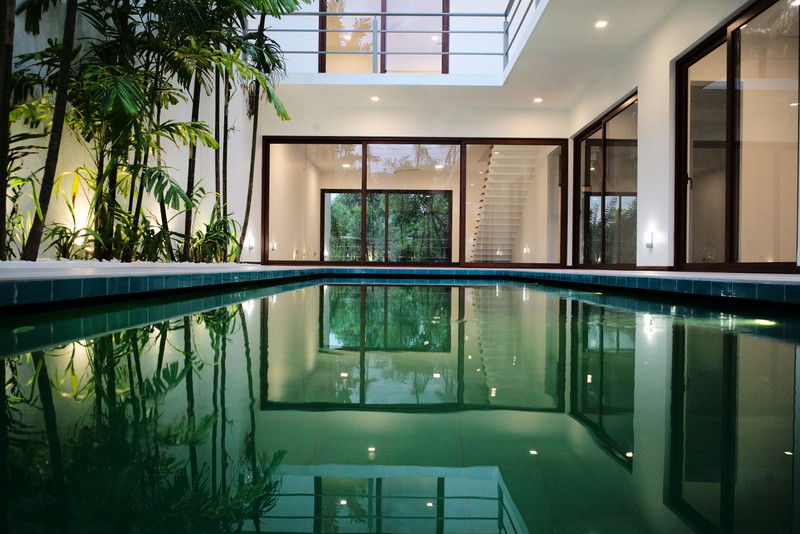 Contemporary residence with an indoor pool and tropical planting